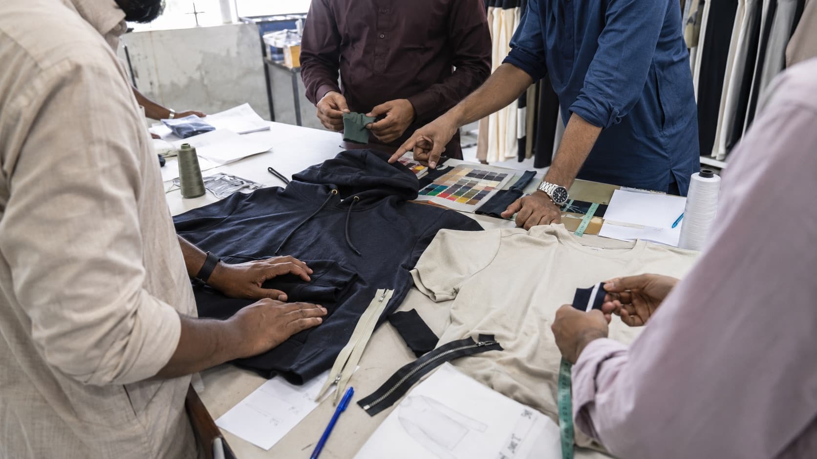 Supplier team reviewing garments, fabric colors and trim options in Pakistan