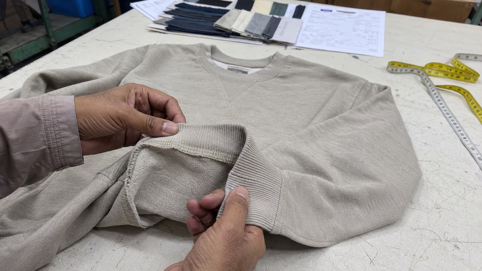 Quality inspector checking knitwear rib, seams and construction