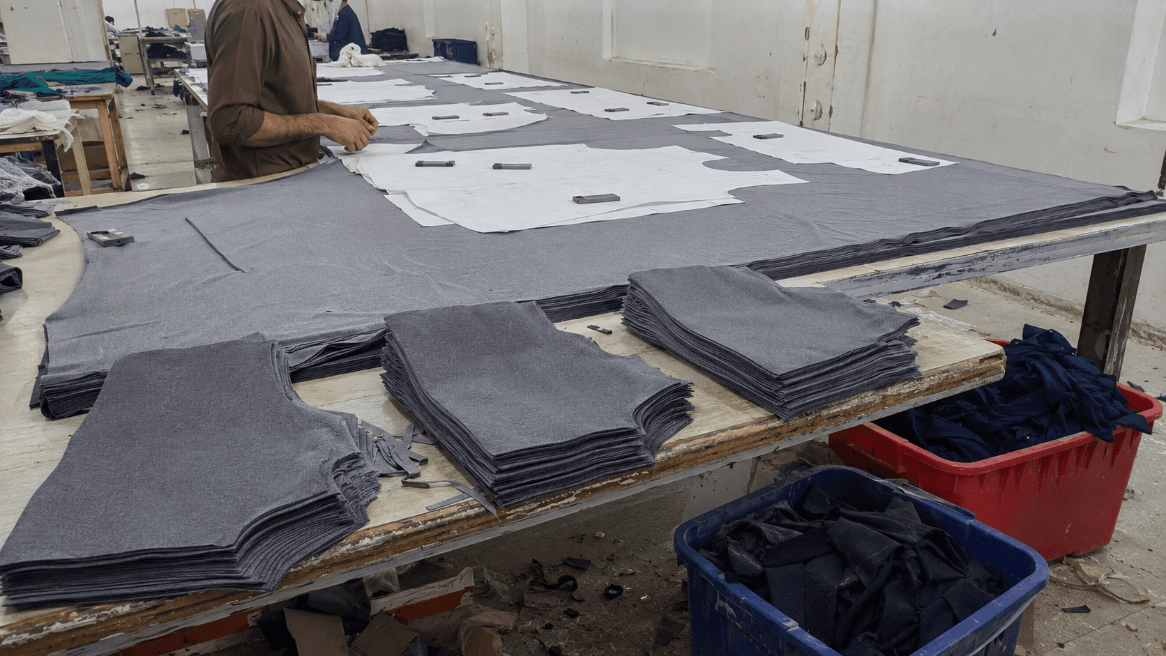 Garment panels arranged efficiently on a knit fabric cutting table
